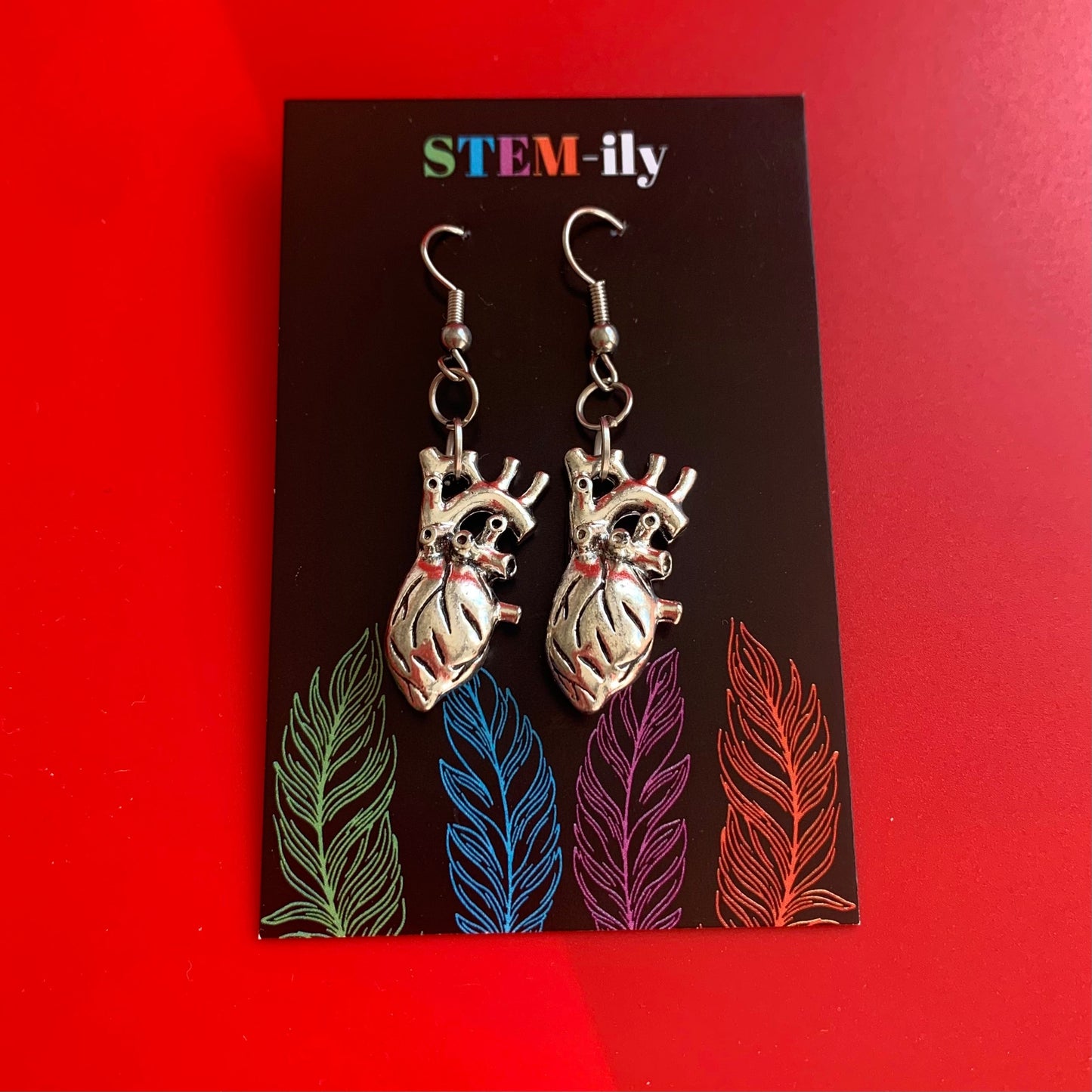 Silver anatomical heart biology dangle earrings on hypoallergenic surgical steel hooks