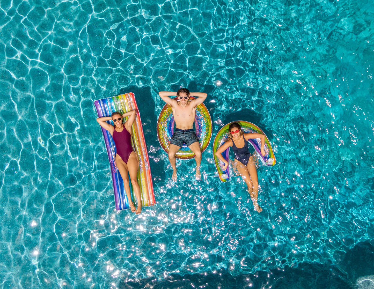 PoolCandy Sun Chair Water Raft – Rainbow Haze Floating Pool Chair