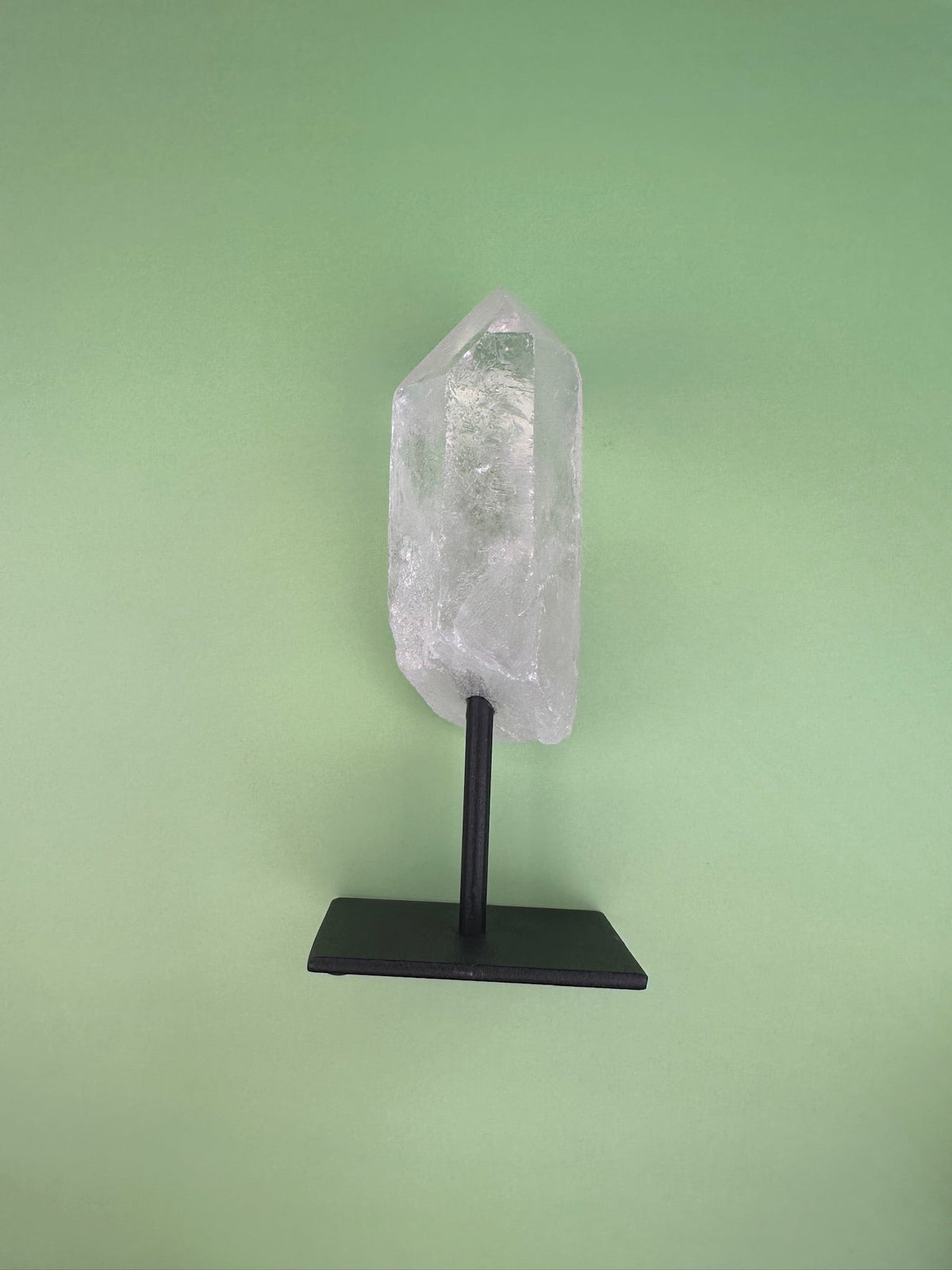 Clear quartz - Rough point on a stand