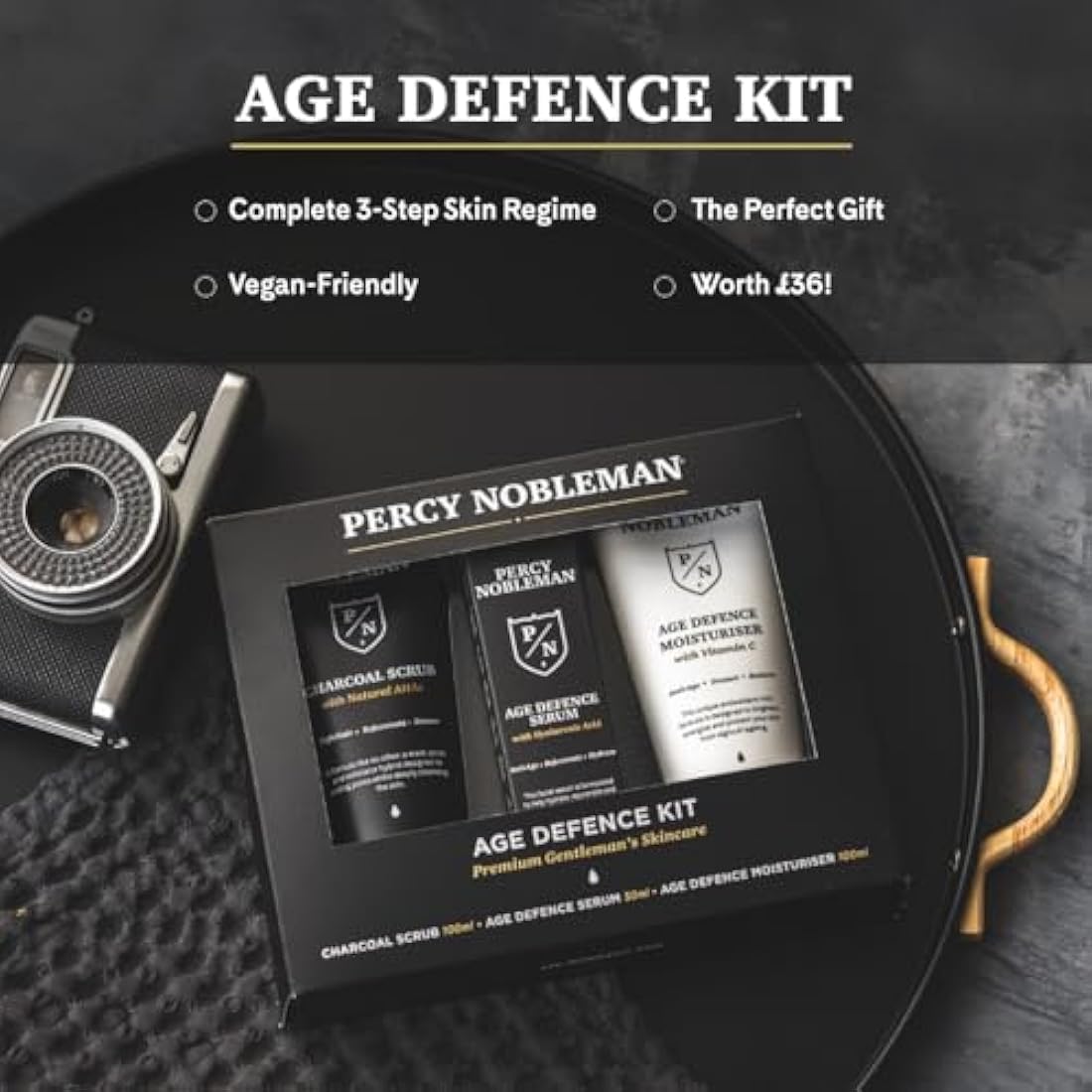 Percy Nobleman Age Defence Kit, a men's skincare set containing Charcoal Face Scrub (with Natural AHAs), ultra-hydrating Facial Serum (with Hyaluronic Acid), and Moisturiser (with Vitamin C)
