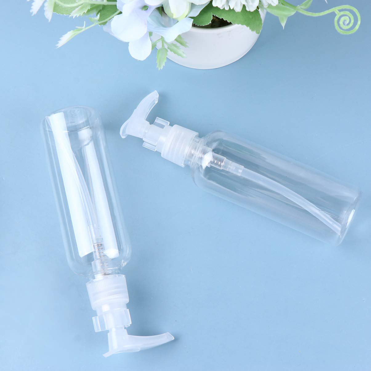 PRETYZOOM 4 pack Travel Pump Bottles 100ml Refillable Plastic Shampoo Dispenser Bottles with Pump for Lotion Liquid Soap Face Wash Essential Oil