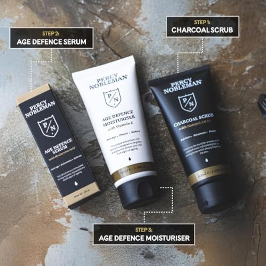 Percy Nobleman Age Defence Kit, a men's skincare set containing Charcoal Face Scrub (with Natural AHAs), ultra-hydrating Facial Serum (with Hyaluronic Acid), and Moisturiser (with Vitamin C)