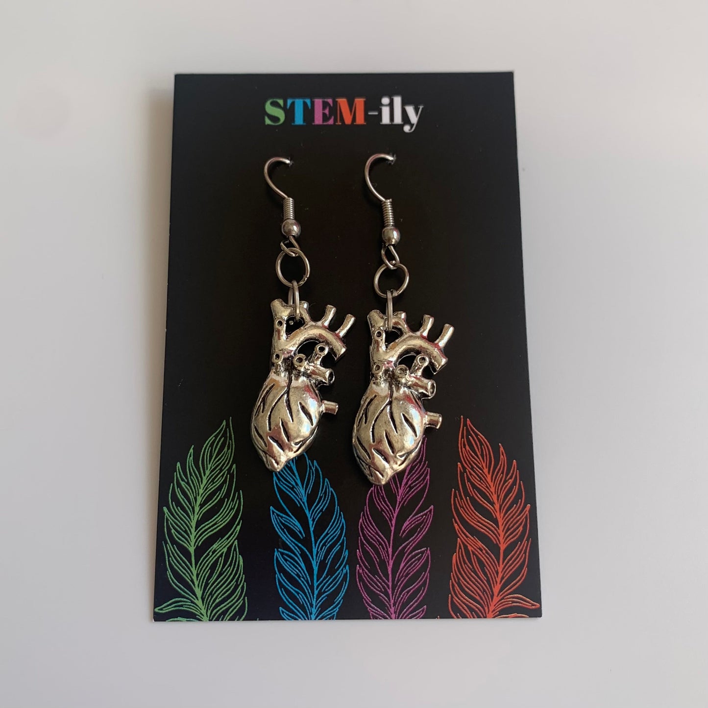 Silver anatomical heart biology dangle earrings on hypoallergenic surgical steel hooks