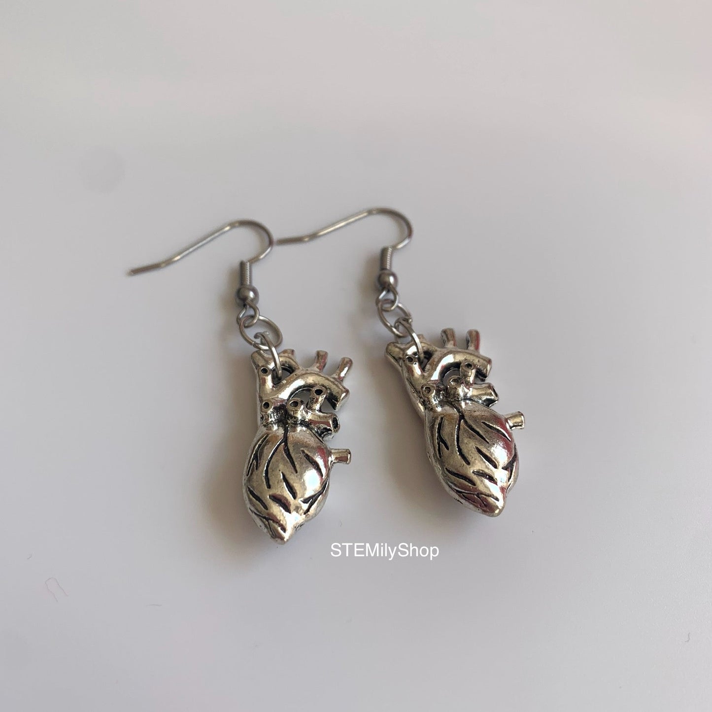 Silver anatomical heart biology dangle earrings on hypoallergenic surgical steel hooks